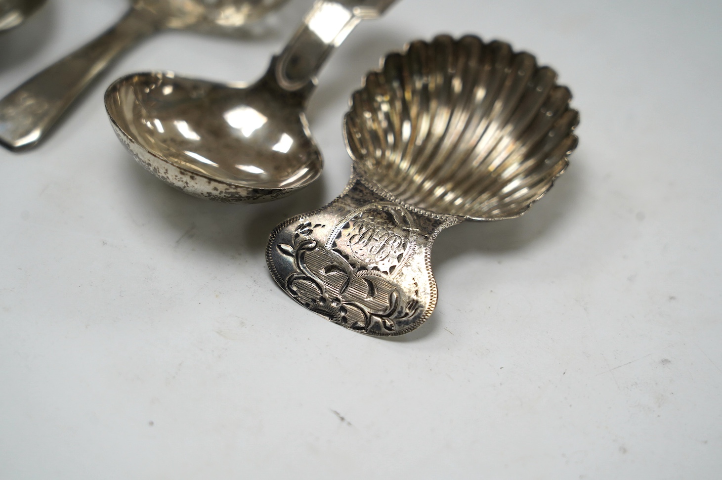 Four assorted silver caddy spoons, including Peter & Ann Bateman, London, 1793, 59mm, reeded handle, Joseph Wilmore?, Birmingham, 1807, pierced bowl, Alice & George Burrows, London, 1809 and curved handle John Lambe, Lon